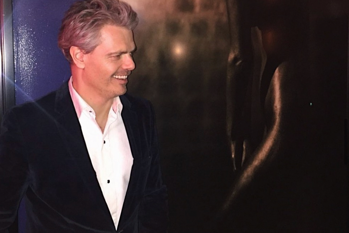 Artist Zack Zublena beside his dark figurative fine art photograph exhibited at The Cellar in Beverly Hills.