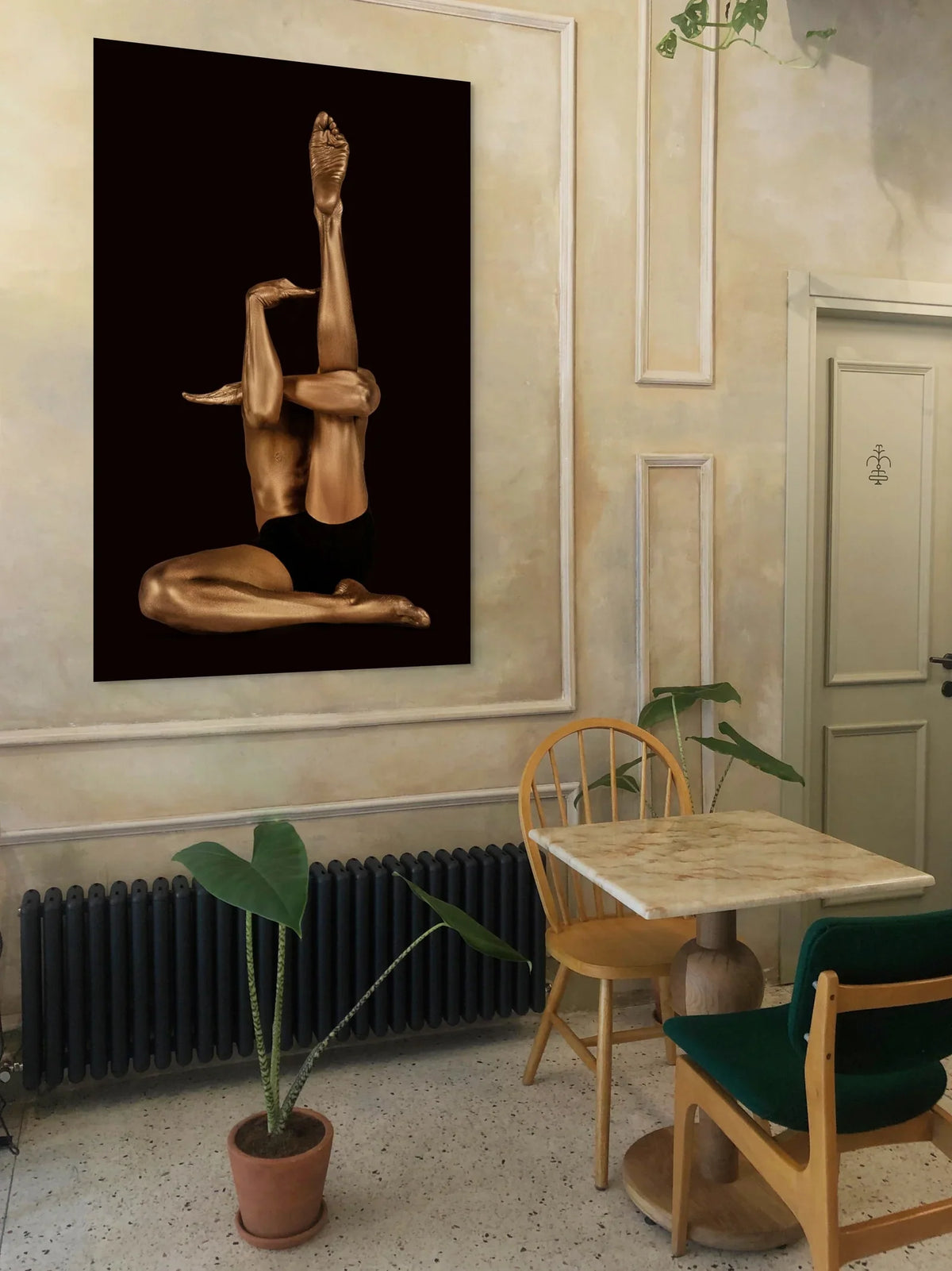 Golden yoga pose fine art photography by Zack Zublena, wall art in a classic interior with white molding, vintage chairs and plants