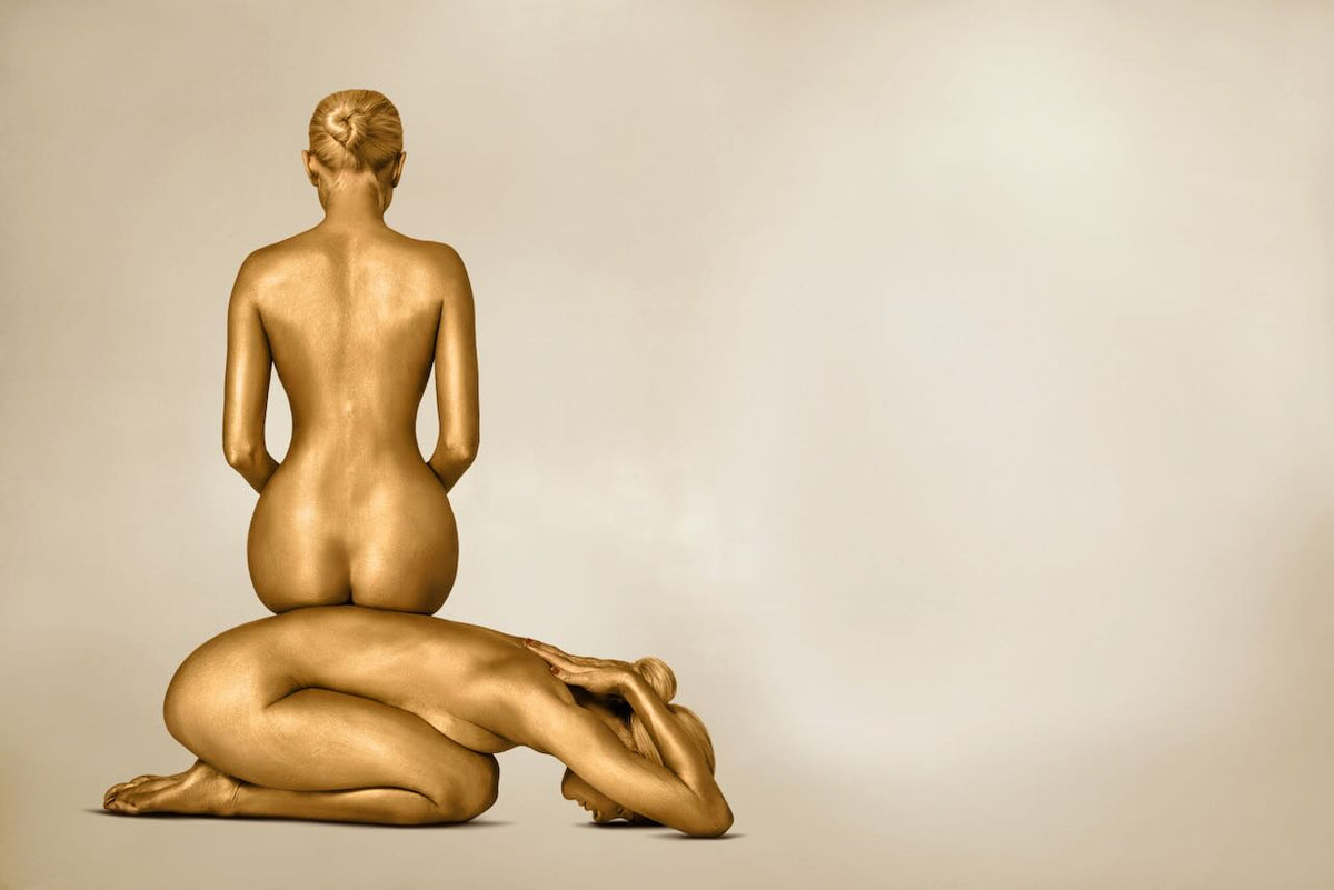 Golden figures sculptural fine art wall print by Zack Zublena, luxury gold body photography for spas, yoga studios, meditation rooms, and hotels.