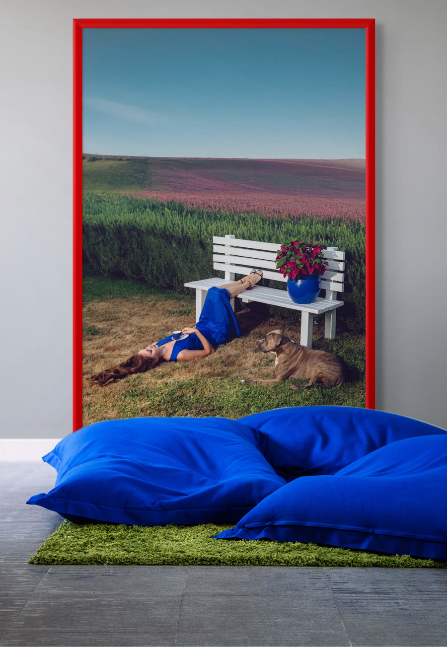 Discover Blue Serenity by Zack Zublena, a surreal fine art photograph blending vibrant landscapes, a woman in a cobalt-blue dress, and her resting dog. Perfect for modern interiors and contemporary art collectors.
