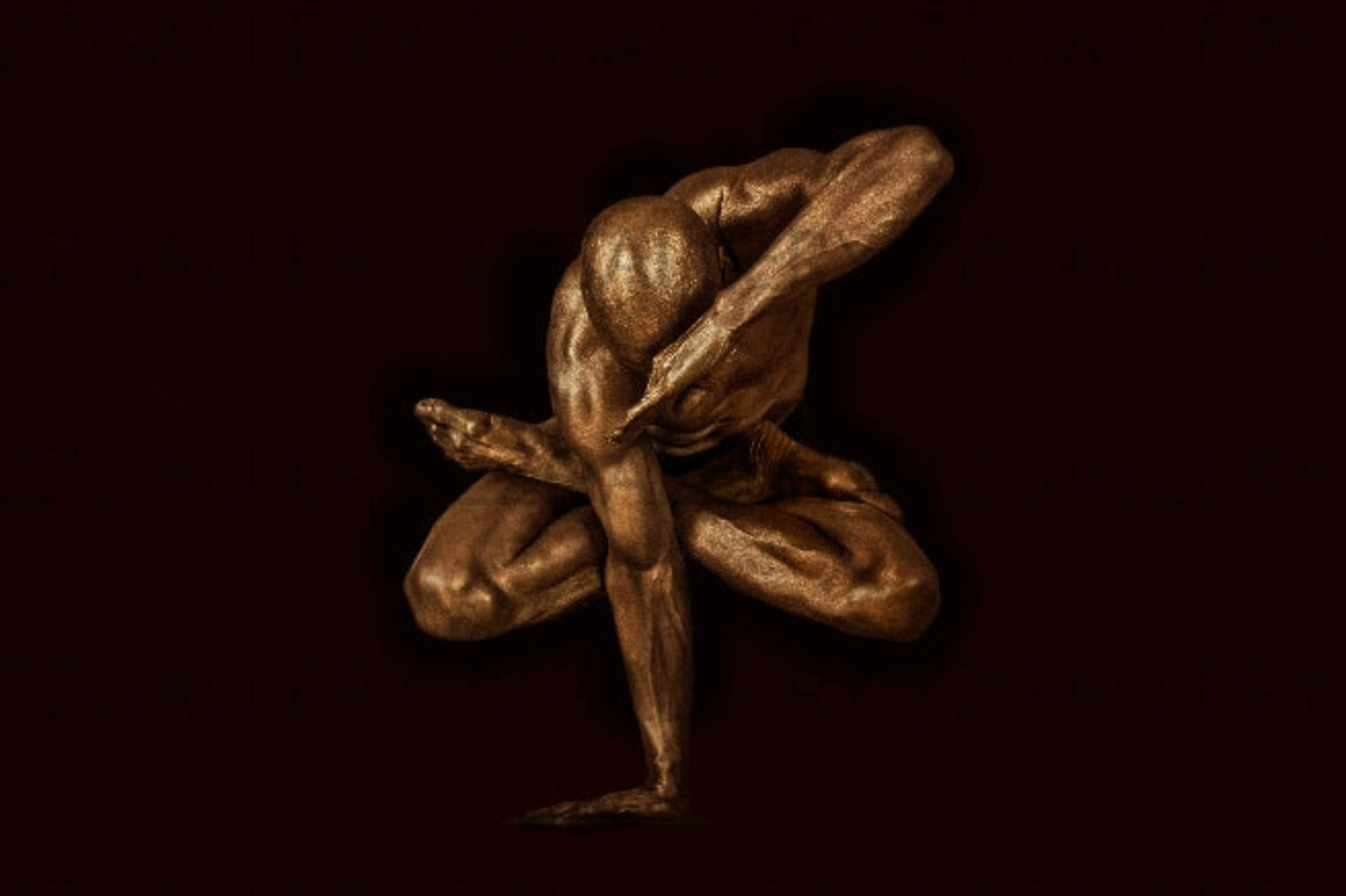Golden-painted male figure in a yoga lotus pose on dark background – luxury sculptural wall art photography
