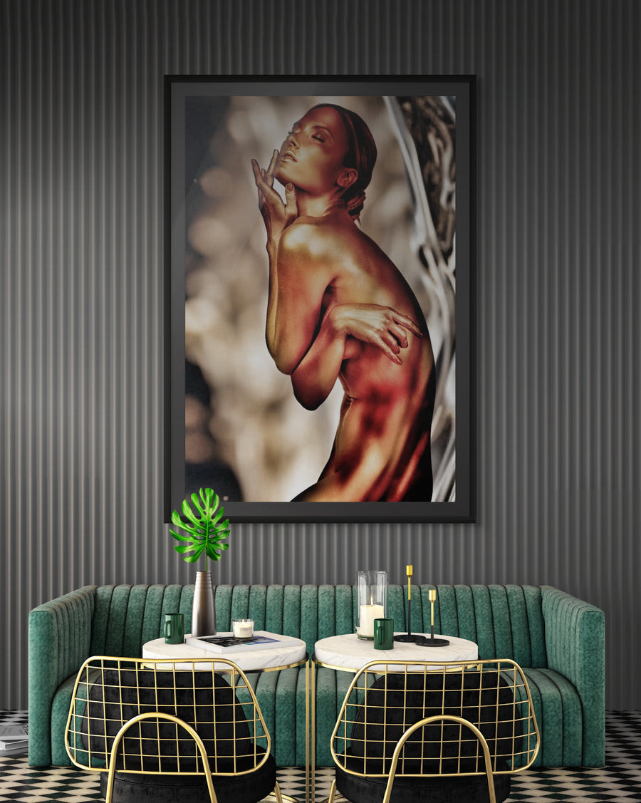 Elegant golden-painted female figure artwork displayed in a sophisticated modern lounge with green velvet seating, marble tables, and gold-accent chairs. Luxury fine art wall decor.