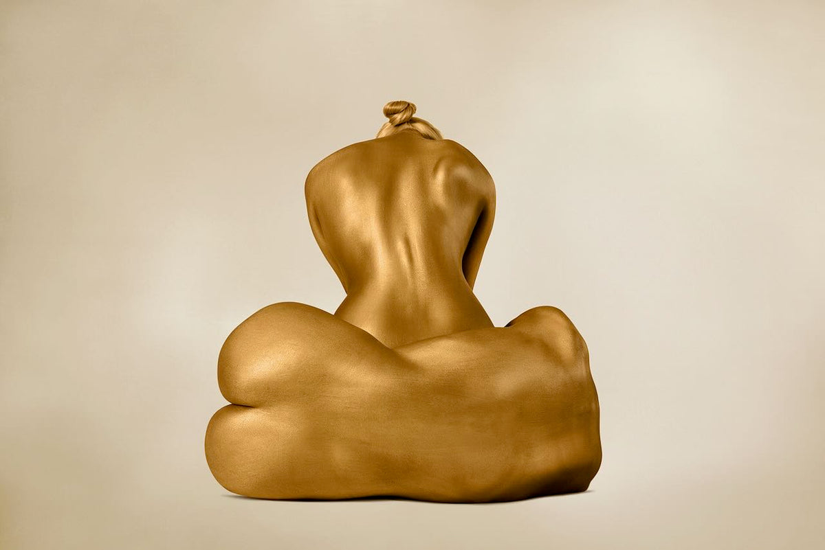 Two golden-painted female figures—one seated upright, one lying sideways—posing in serene harmony, ideal for spiritual and luxury wall art decor.