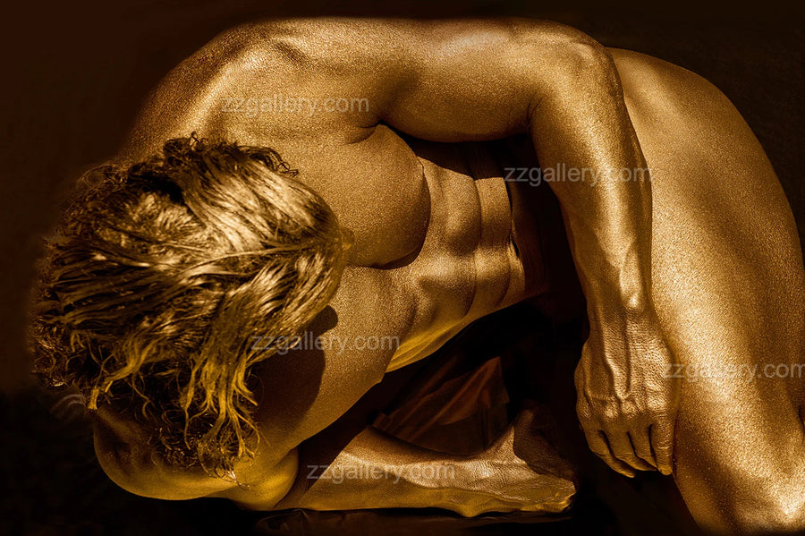 Golden-painted male figure in introspective pose by Zack Zublena, contemporary fine art photography, luxury wall art symbolizing strength, vulnerability, and meditative stillness.