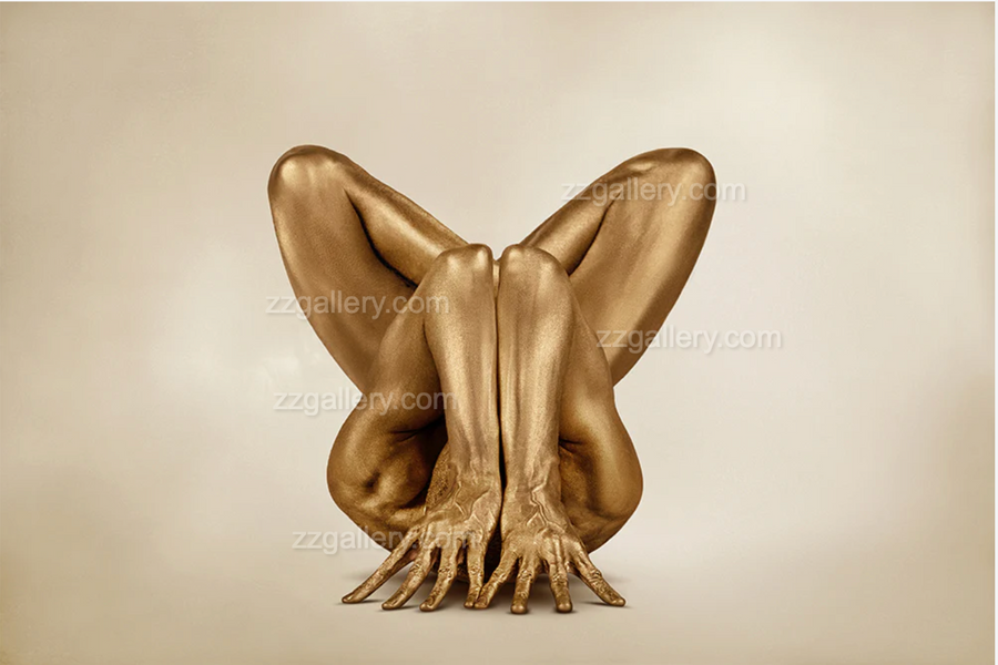 Golden yogi in sculptural yoga pose with legs crossed and hands grounded, fine art photography for luxury interior wall decor.