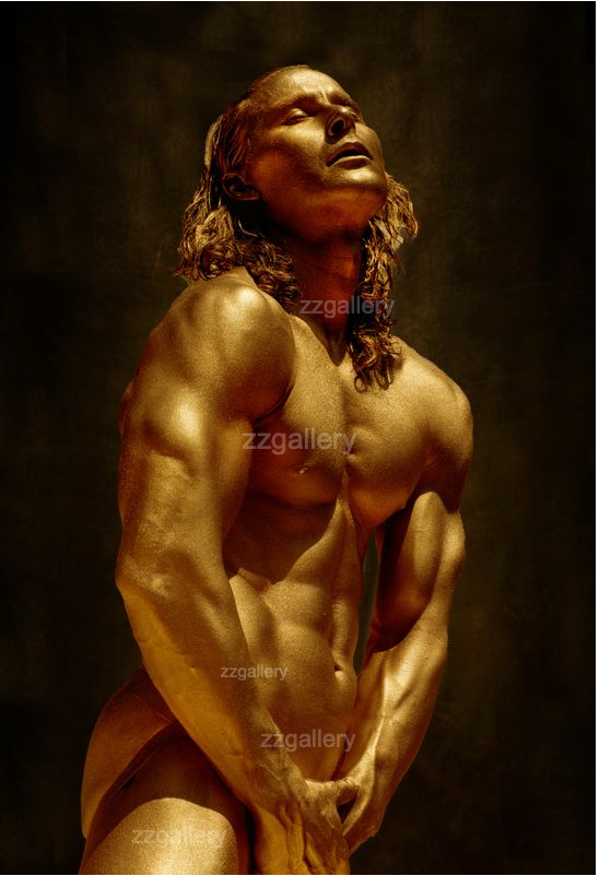 Golden masculine figure wall art – fine art photography of a powerful male form painted in shimmering gold tones, displayed as luxury décor in a modern bedroom interior.