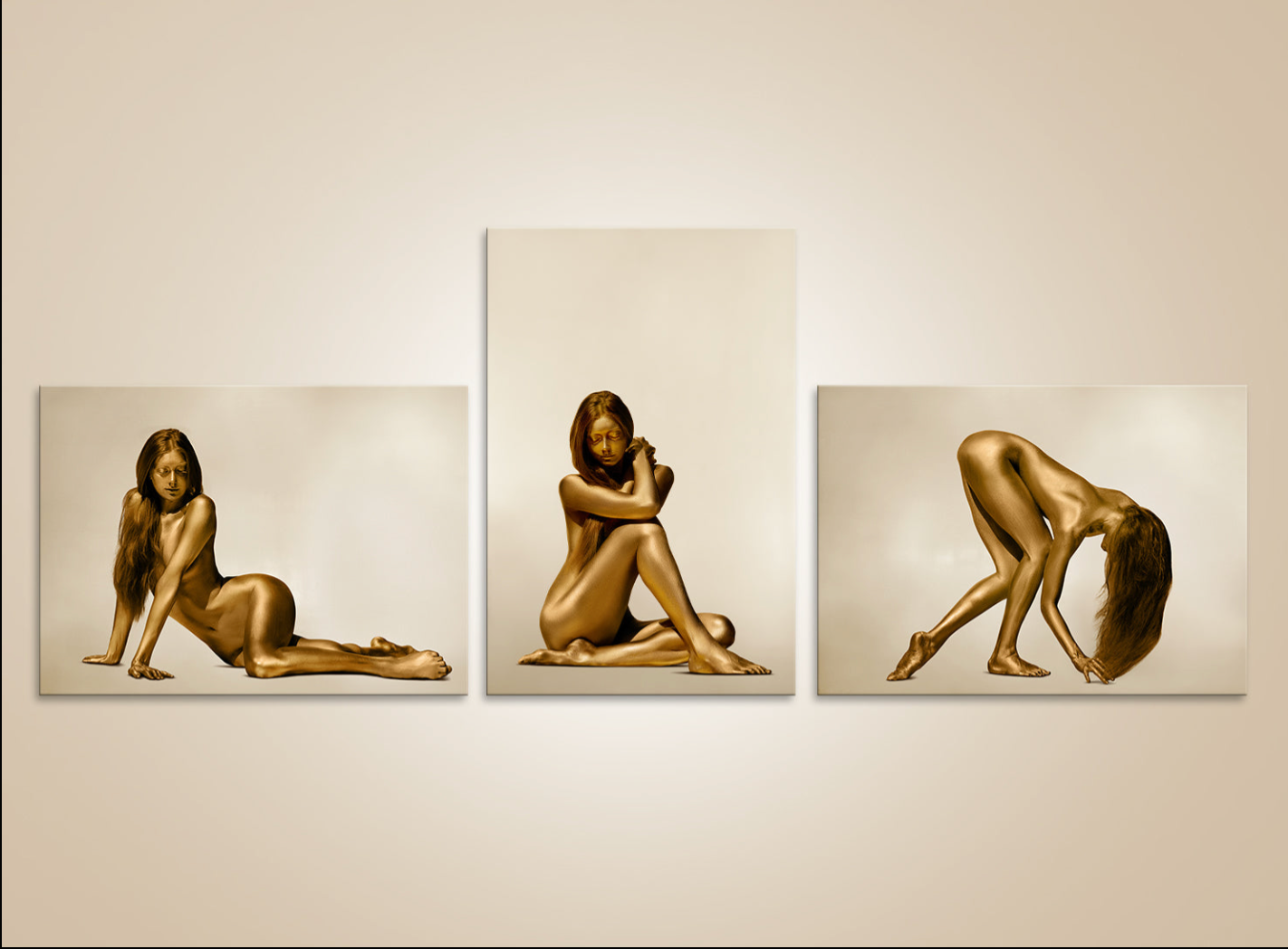 Golden nude female triptych wall art – fine art photography of gold-painted female body in elegant poses for luxury interiors and art collectors.