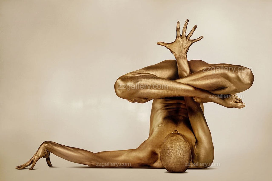 Golden painted body in advanced yoga hand balance pose, fine art wall decor by Zack Zublena, displayed in a modern gym with blue walls and treadmill.