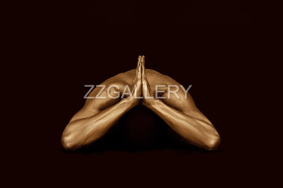 Golden-painted male torso in a headless prayer pose against a deep black background — fine art meditation photography by Zack Zublena, from the Vacuum State Collection.