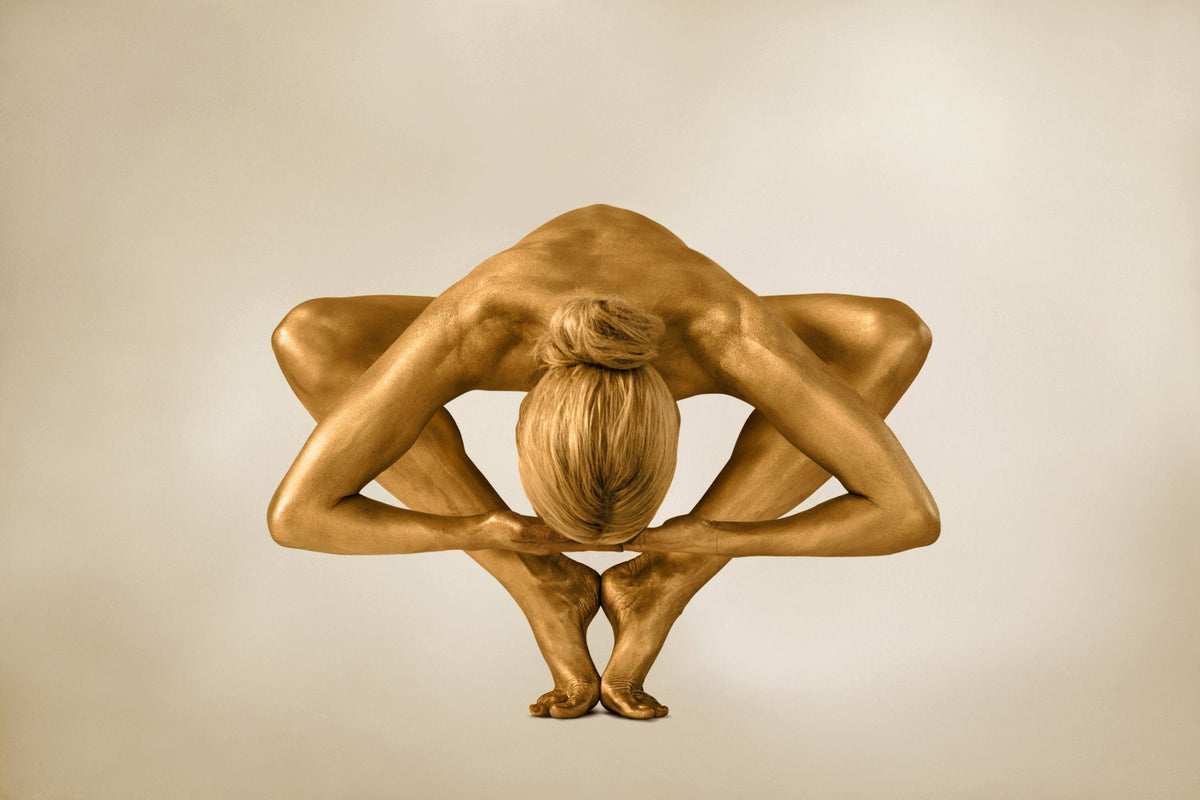 Sculptural fine art photography of a golden figure folded into a geometric yoga pose by Zack Zublena, luxury wall art.