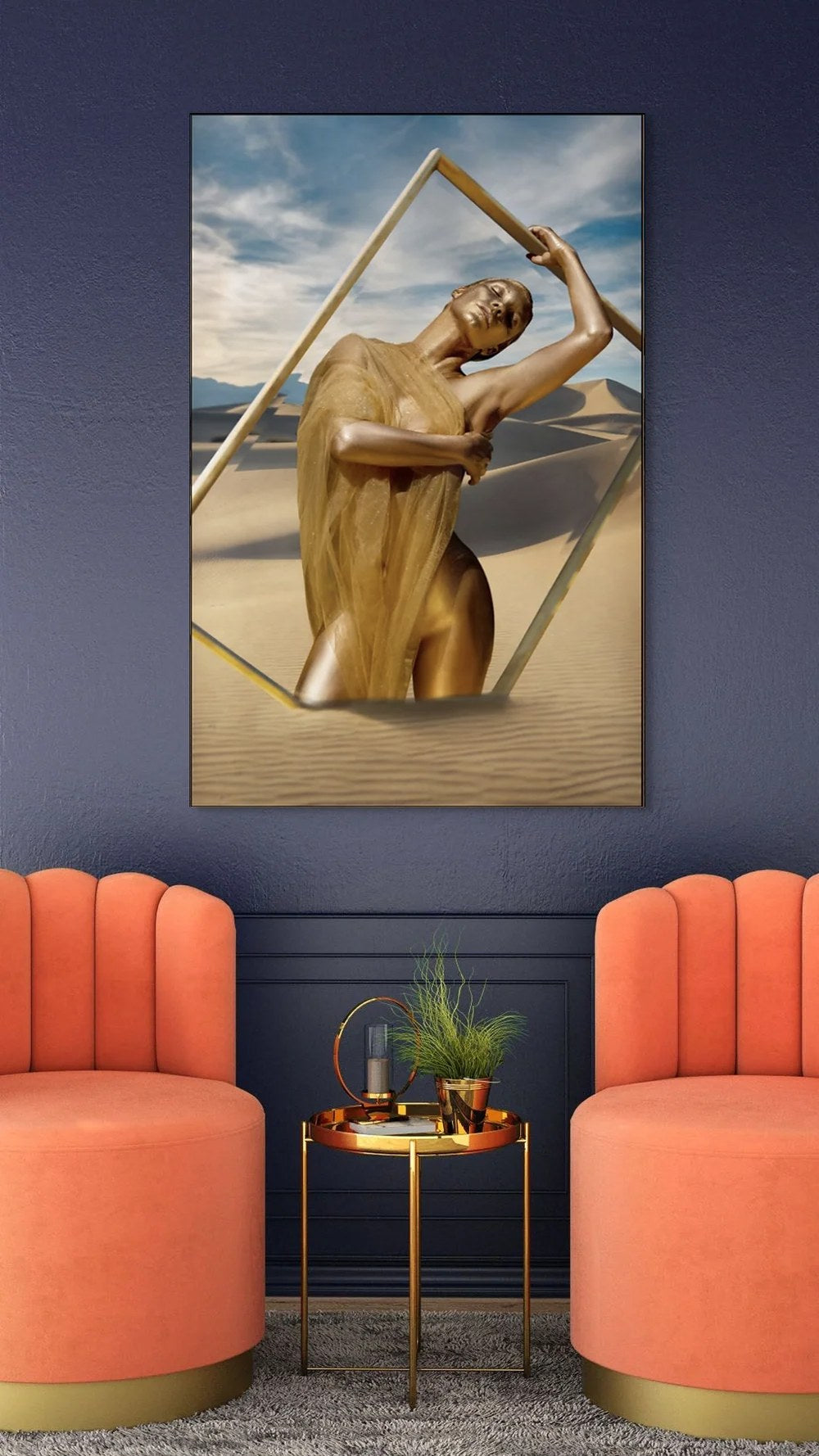 Golden-painted feminine figure draped in translucent golden fabric, posing in a desert landscape with a modern geometric frame — fine art wall photography.