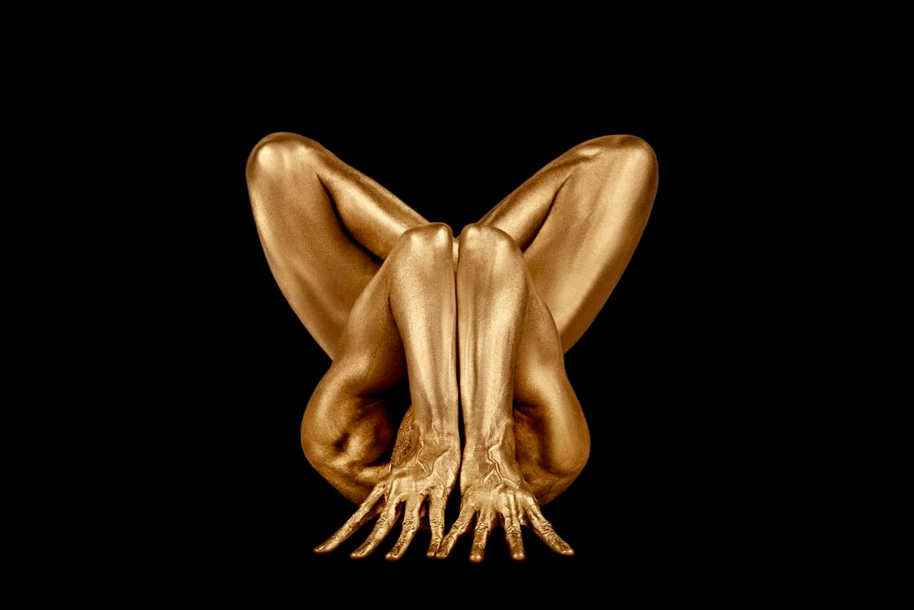 Zack Zublena fine art photograph featuring a golden yoga-inspired figure in contemplative pose. A sculptural composition highlighting balance, form, and elegance.