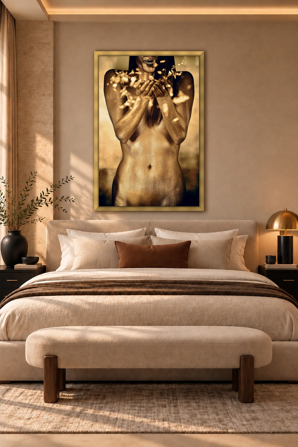 "A Thousand Suns Transmission," a gold body paint fine art photograph by Zack Zublena, framed in metallic gold above a cream upholstered bed in a warm, sunlit luxury bedroom.