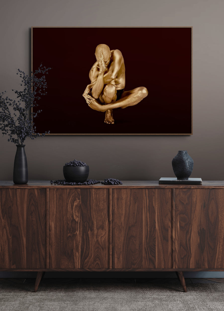 Golden-painted male figure in a defensive seated pose, fine art photography from Zack Zublena’s Midnight Bronze Collection, titled “Centurion’s Oath.”