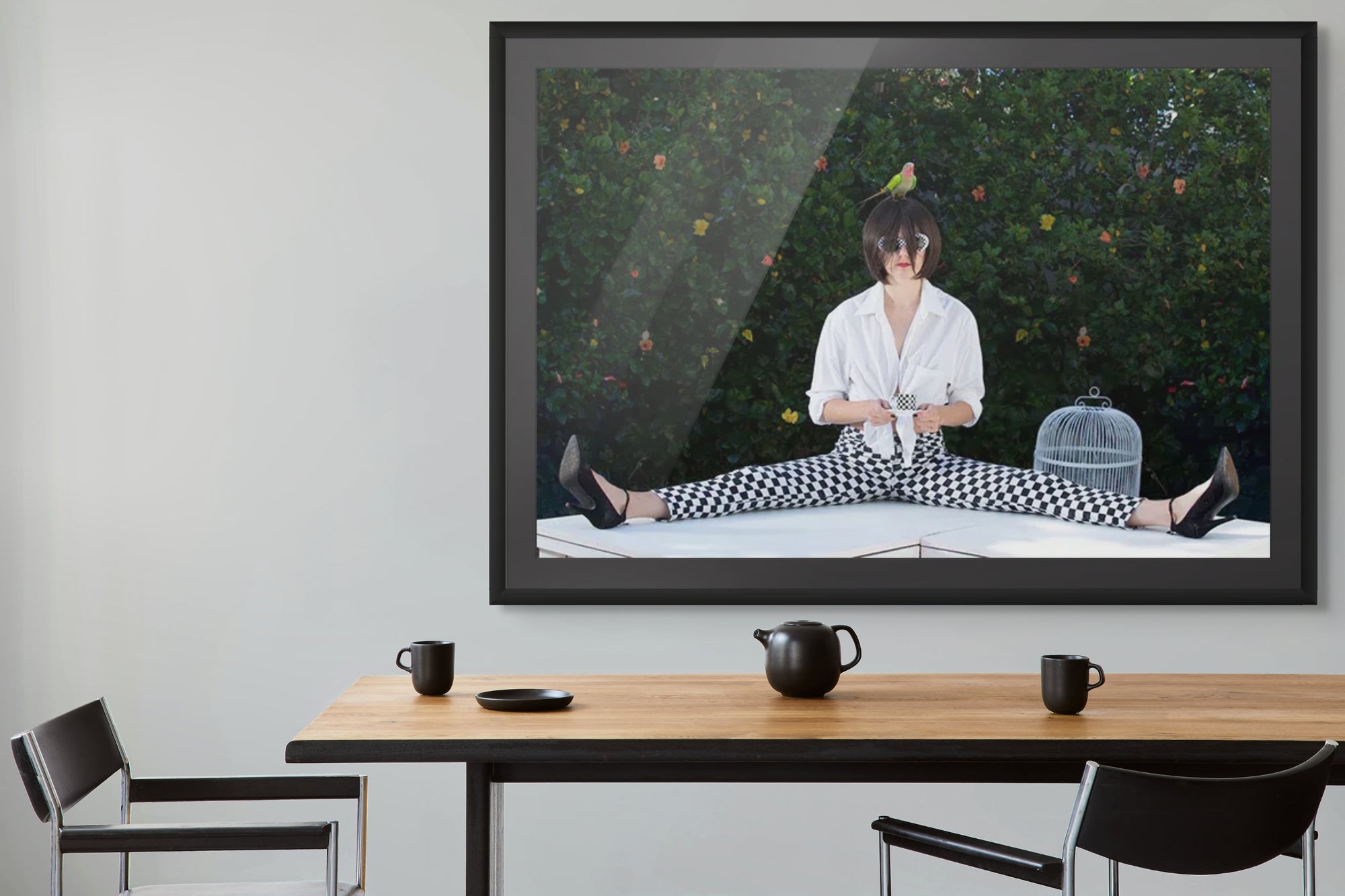 Whimsical surreal fine art photograph Coffee Time by Zack Zublena, featuring a woman in checkerboard pants sipping coffee with a bird on her head.