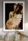 Golden surreal female artwork with fractured face and angel wing, displayed in an elegant interior with vases and natural light.