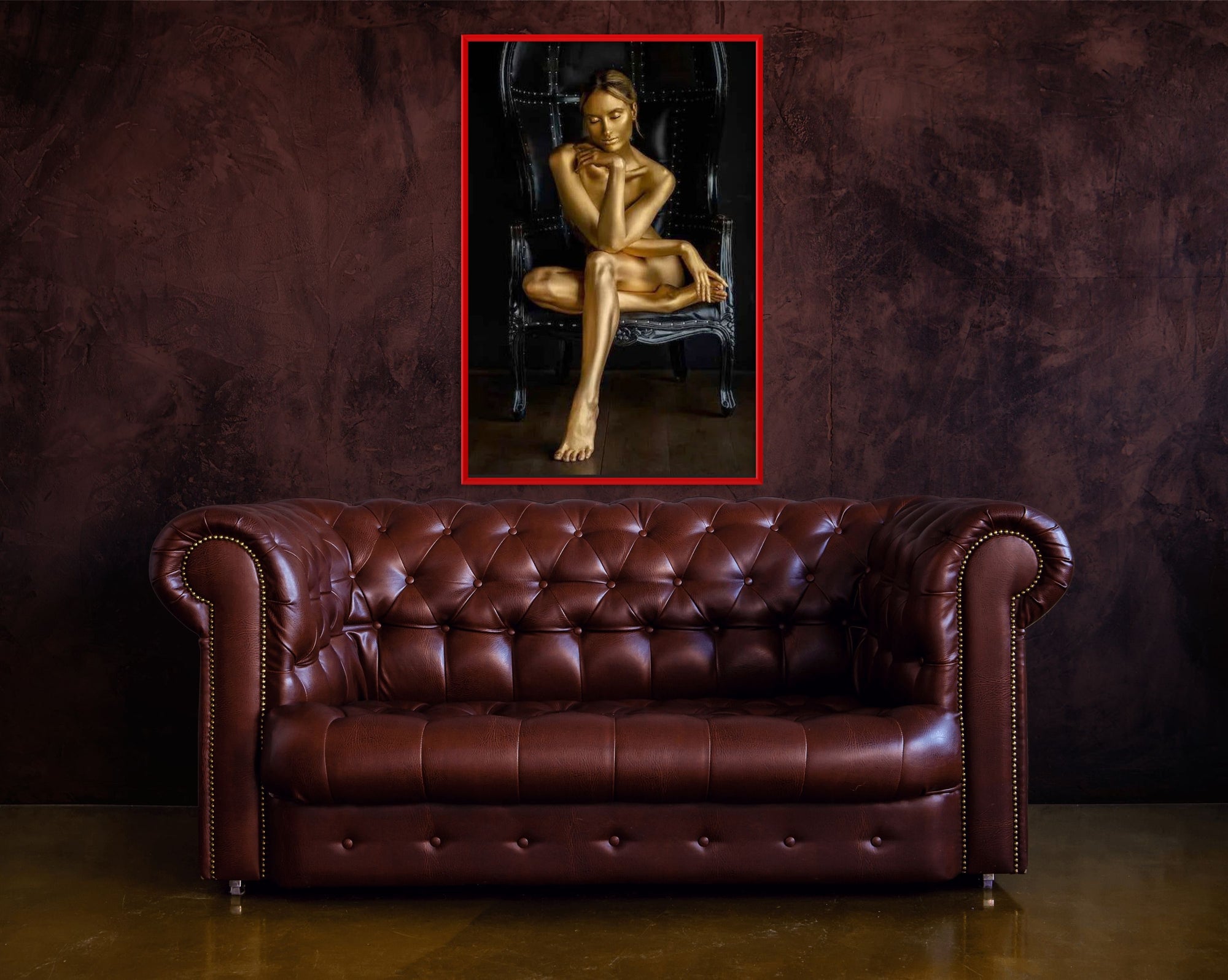 Elegant living room with a tufted brown leather Chesterfield sofa against a dark textured wall, featuring a framed golden fine art painting of a woman seated on a black chair