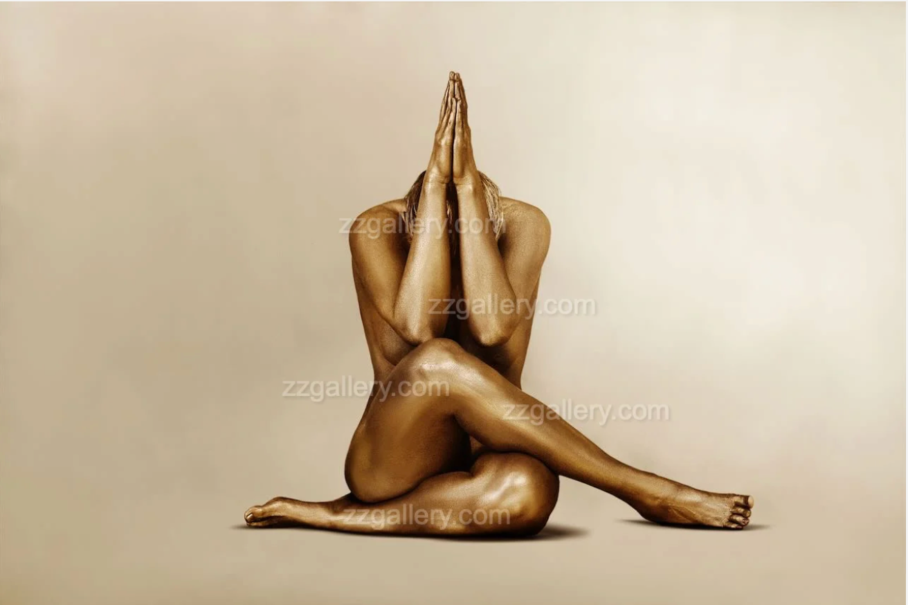 Golden fine art photograph of a seated figure with hands pressed together, yoga-inspired pose by Zack Zublena.