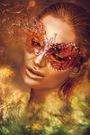 Golden woman wearing intricate red mask, emerging from fiery green mist – surreal and mystical fine art by Zack Zublena.