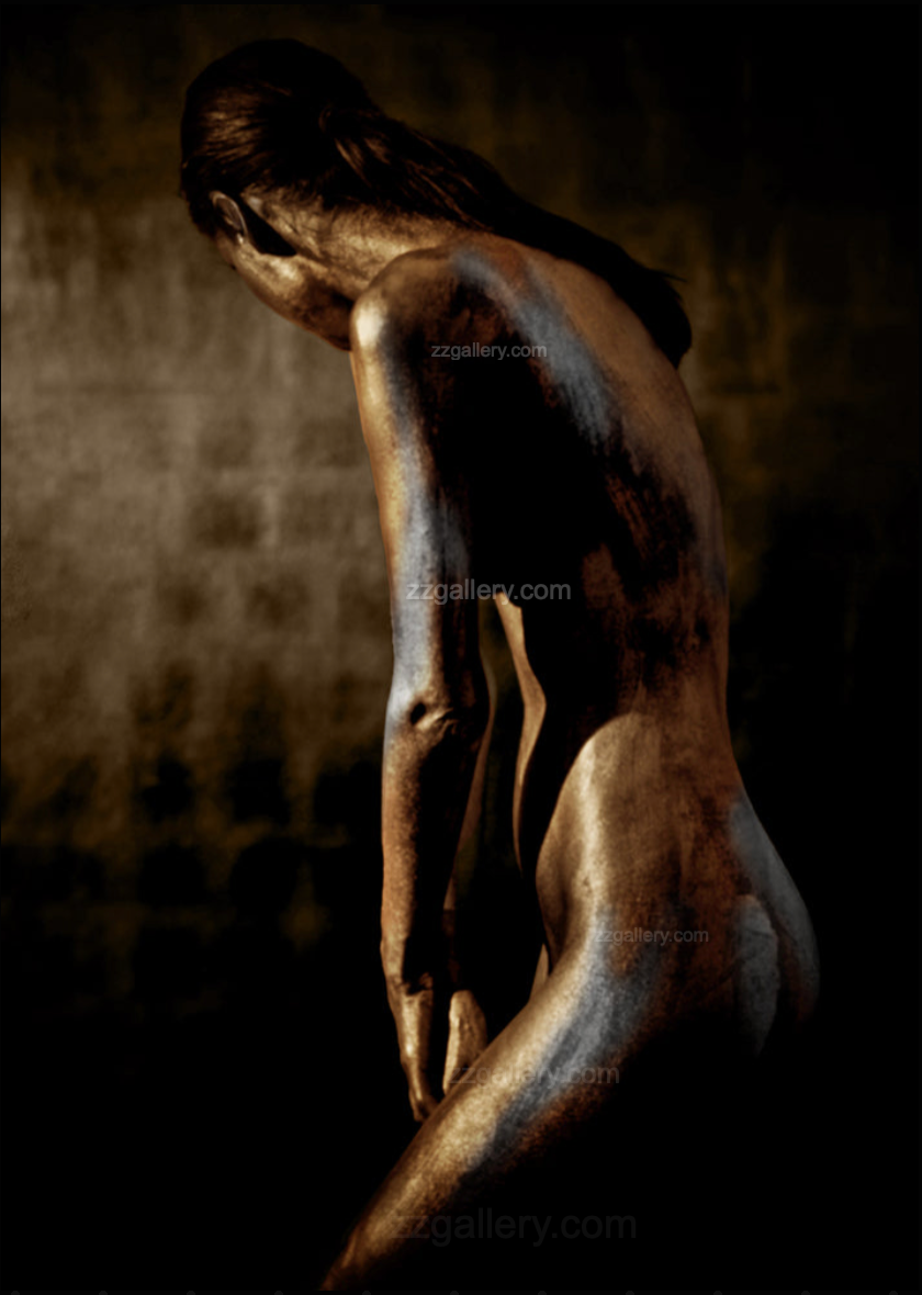 Gold and silver-painted figure in bowed pose, fine art photography capturing introspection and divine feminine stillness