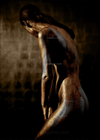 Gold and silver-painted nude female figure in bowed pose, fine art photography capturing introspection and divine feminine stillness