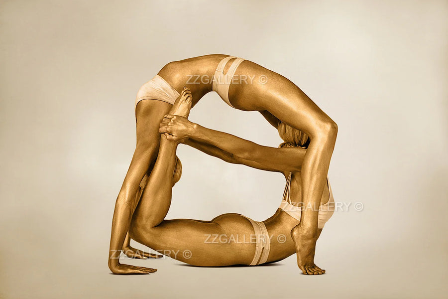 Golden acrobatic female duo in balance pose, luxury fine art photography for hotel, spa, wellness, and contemporary interiors