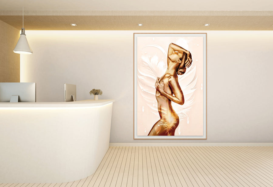 Elegant golden nude angel artwork with feather wings displayed in a modern spa reception area with minimalist white design.