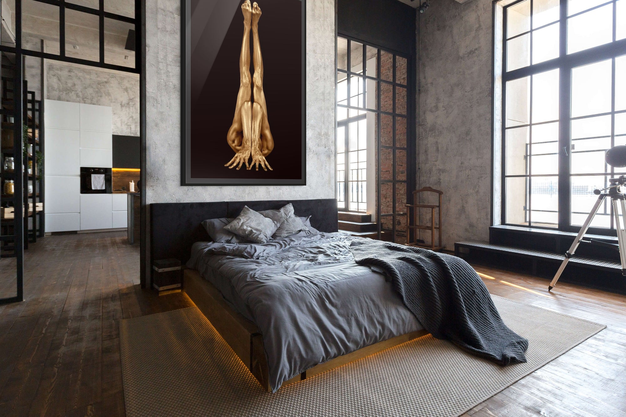 Gold-painted male figure in a vertical inverted pose, arms extended upward and legs together, set against a dark background. Contemporary fine art wall photography by Zack Zublena.