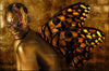 Golden-painted woman wearing an ornate masquerade mask with radiant butterfly wings, blending mystery, transformation, and divine feminine beauty in fine art photography by Zack Zublena.