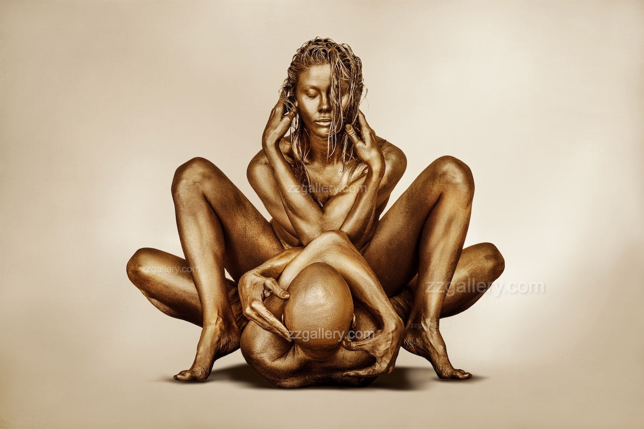 Golden-painted couple in an artistic embrace, sculptural fine art photography emphasizing harmony, strength, and balance — ideal for luxury interiors, spas, and collectors.