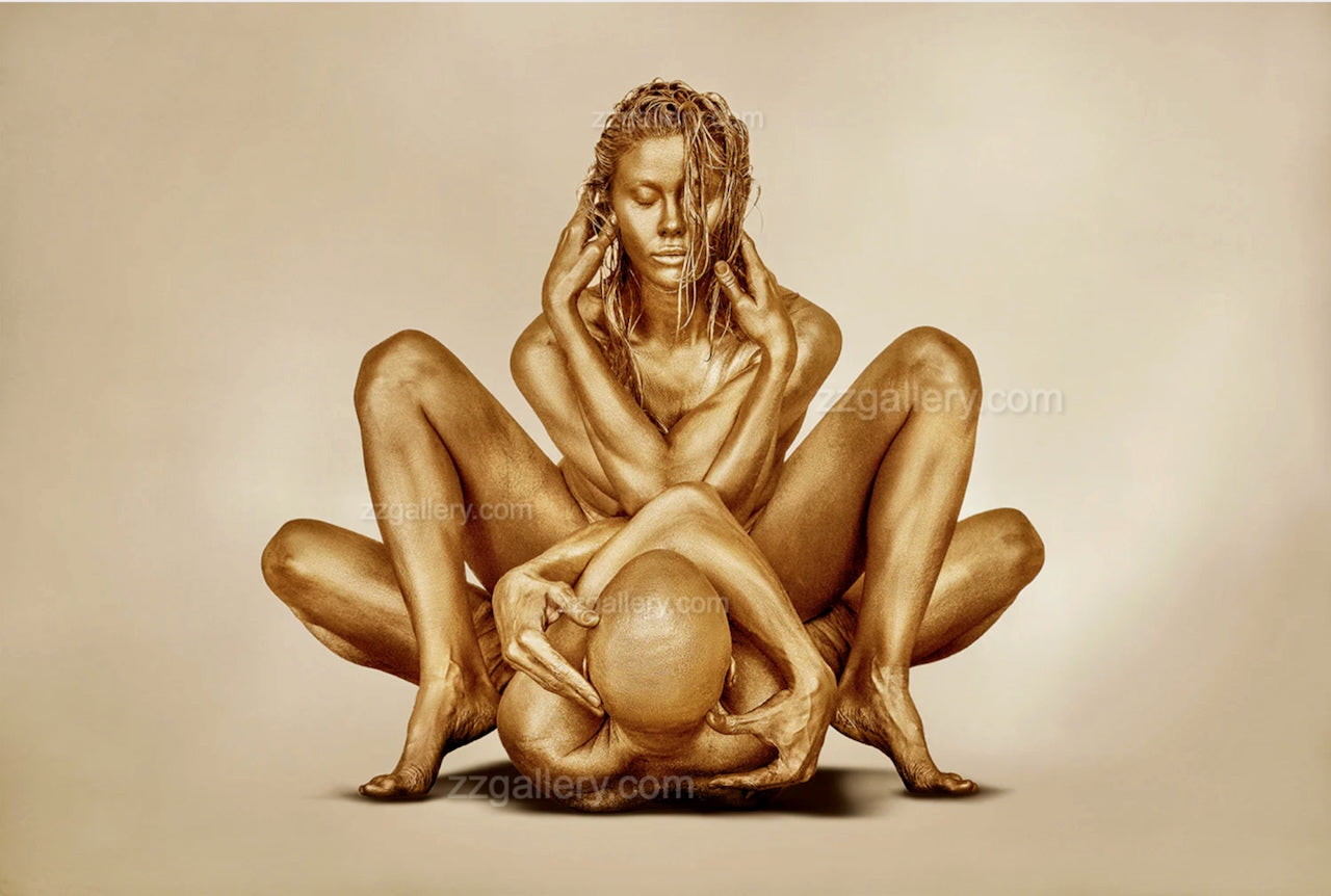 Golden-painted couple in a meditative embrace, posed in a balanced yoga-inspired position. Artistic fine art photography highlighting harmony, connection, and serenity in a golden style.