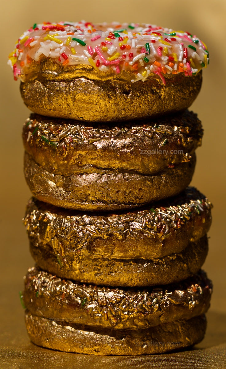 Golden donuts stack fine art photograph with sprinkles, luxury dessert wall art for kitchens, cafés, restaurants, and modern interiors.