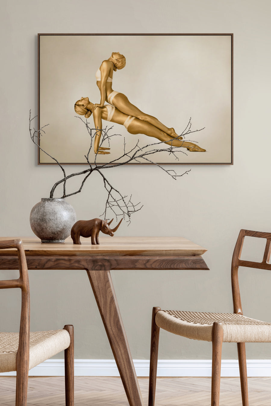 Fine art photography of two golden-painted female figures in a synchronized yoga pose, captured as contemporary wall art for luxury interiors, yoga studios, and modern wellness spaces.