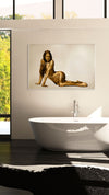 Gold-painted nude woman wall art displayed above a bathtub in a luxurious bathroom setting.