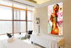 Golden nude female fine art photograph with floral background displayed in a serene spa treatment room with massage tables and natural light.