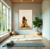 Serene yoga studio with a large framed artwork of a golden-painted nude woman in a seated pose. Elegant fine art wall decor evoking Aphrodite’s beauty, tranquility, and inner harmony.