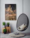 Golden feminine fine art photography by Zack Zublena displayed in a contemporary interior with a hanging chair, plants, and minimalist decor