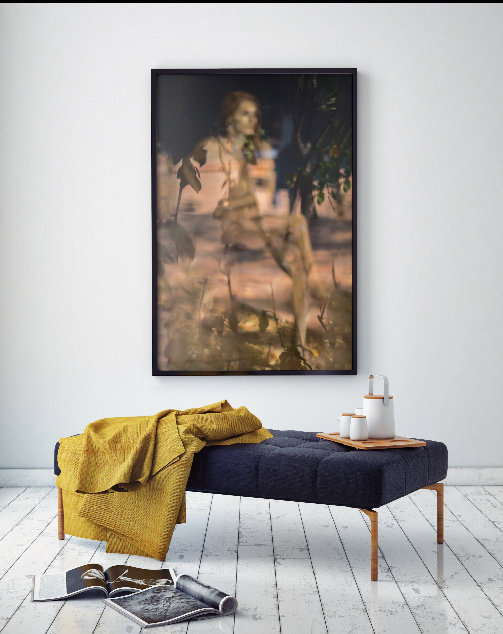 Golden feminine fine art photography by Zack Zublena displayed in a modern interior with a yellow blanket on a bench and white wooden floor