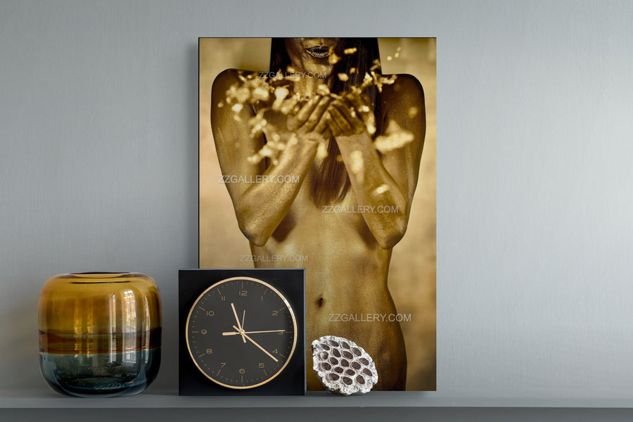 Golden-painted woman blowing radiant particles of light from her hands, symbolizing feminine energy, blessings, and divine transmission in contemporary fine art photography by Zack Zublena.