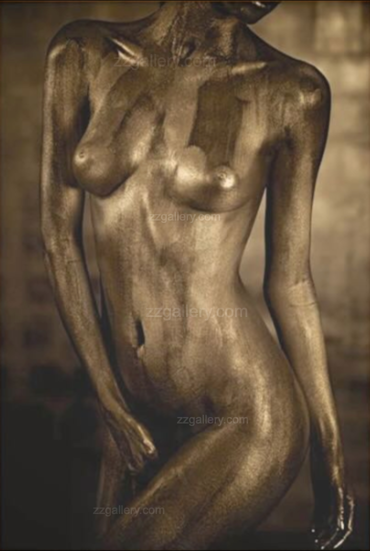 Bronze statue of a figure with a blurred background