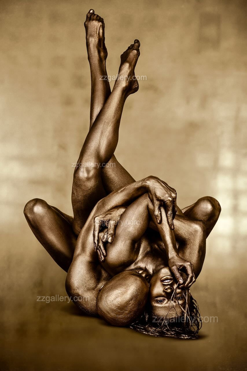 Golden-painted figure in a sculptural yoga-inspired balance pose, fine art photography by Zack Zublena for luxury interiors, spas, and collectors.