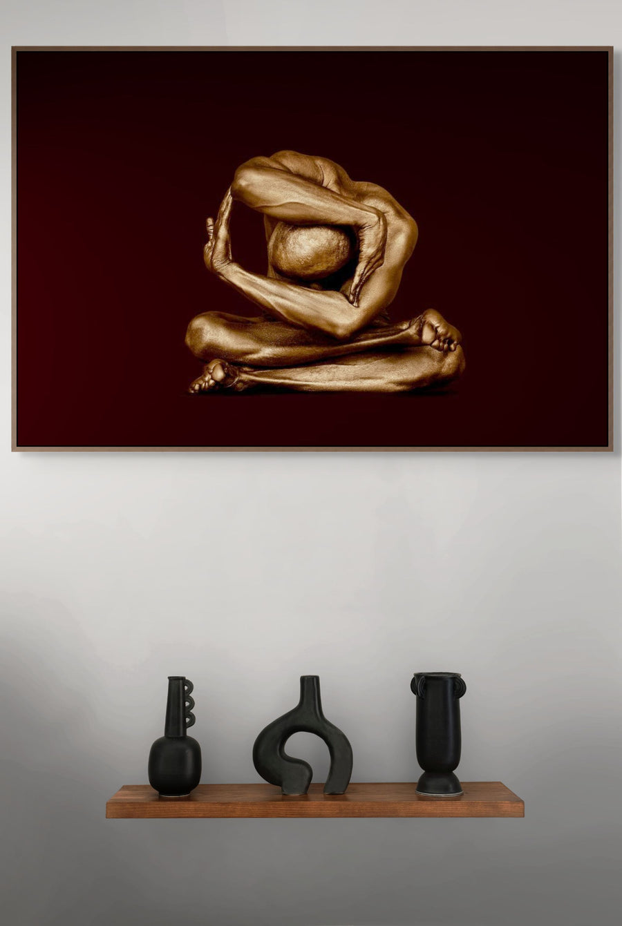 Golden-painted figure seated with crossed legs and arms curved overhead in an abstract pose — fine art wall photography by Zack Zublena, perfect for luxury interiors and contemporary collections.