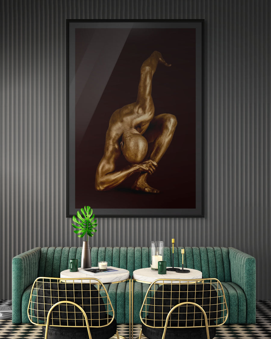 Contemporary fine art photography by Zack Zublena featuring a gold-painted figure in a dramatic forward bend with one leg lifted, embodying strength, balance, and modern sculptural elegance on a moody dark background. Perfect for luxury wall decor and wellness-inspired interiors.