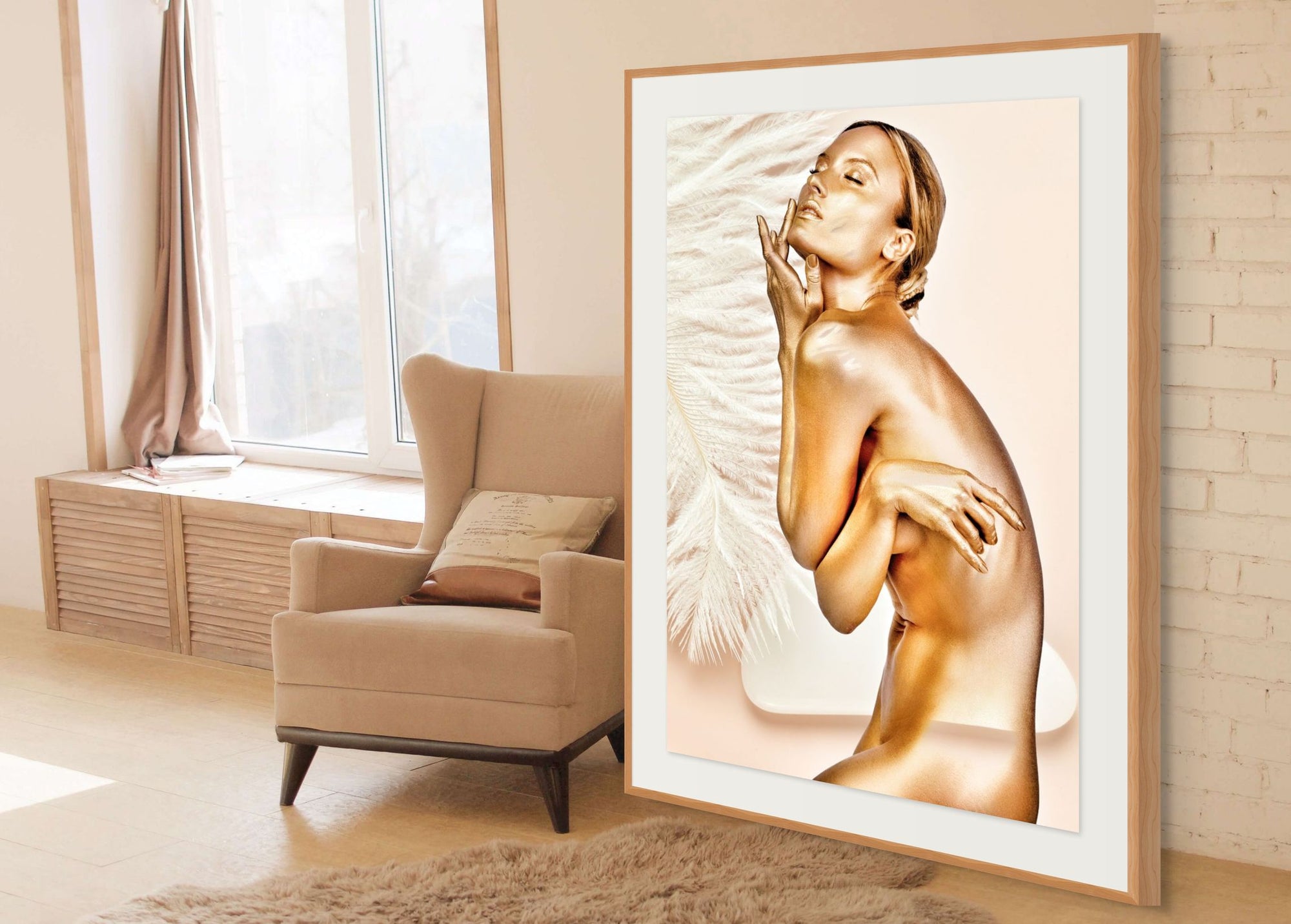 Golden-painted female figure in elegant fine art photography, posed gracefully beside soft white feathers, symbolizing divine feminine beauty, purity, and transformation.