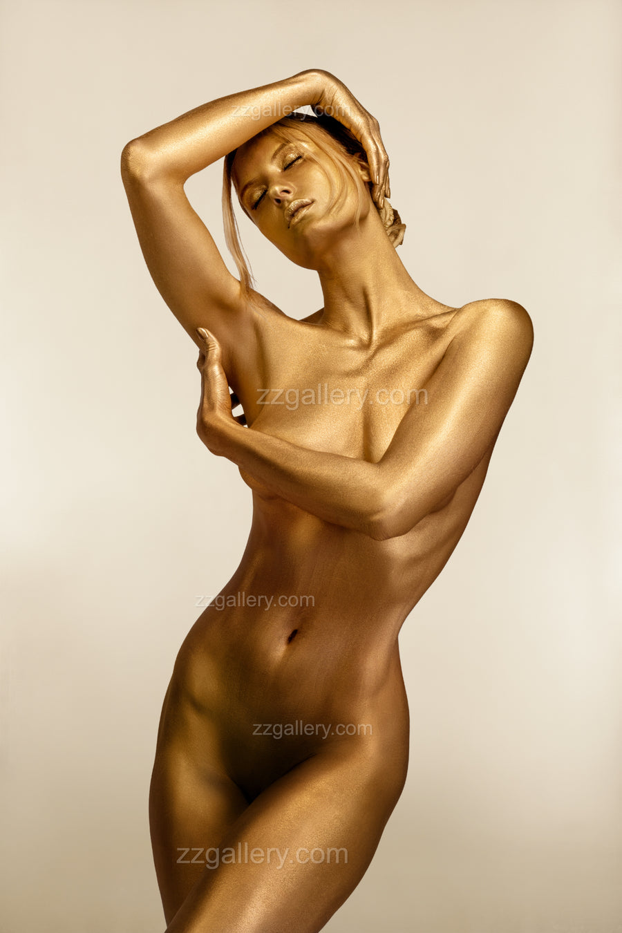 Golden-painted nude woman posed with elegance, displayed as fine art photography by Zack Zublena above a luxury indoor pool, blending sensuality, grace, and contemporary sophistication.