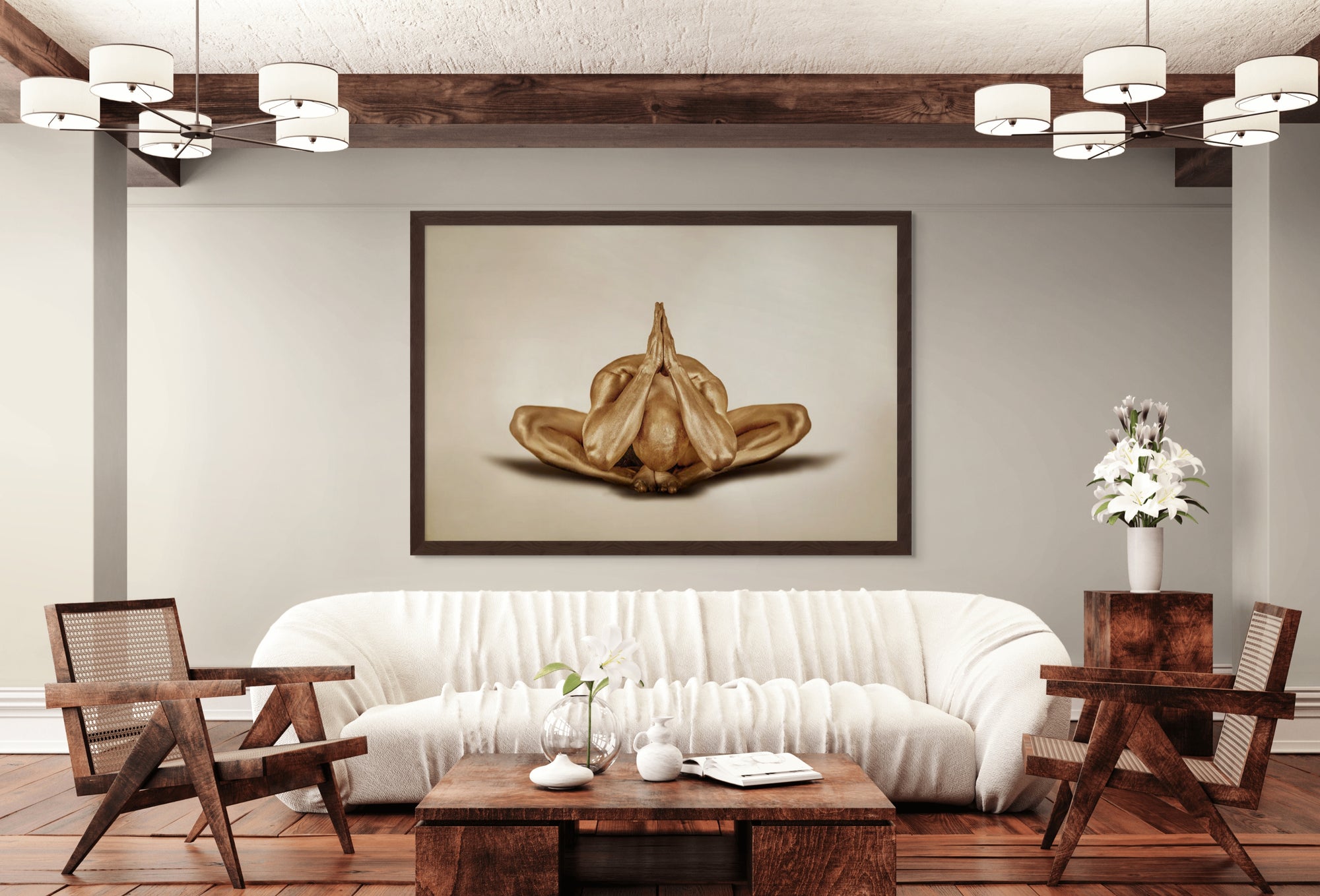 Golden-painted male figure in a meditative yoga pose with hands pressed together, displayed as fine art wall décor in a modern living room interior.
