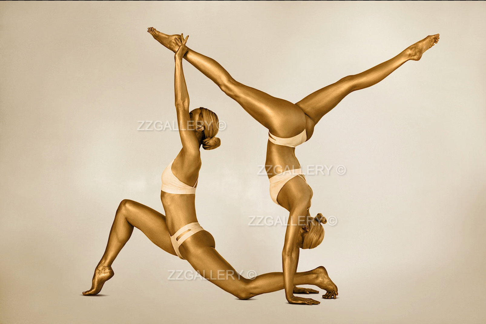 Golden duo in sculptural yoga balance pose, fine art photography symbolizing kinship, harmony, and unity. Luxury gold artwork for spa and interior design.