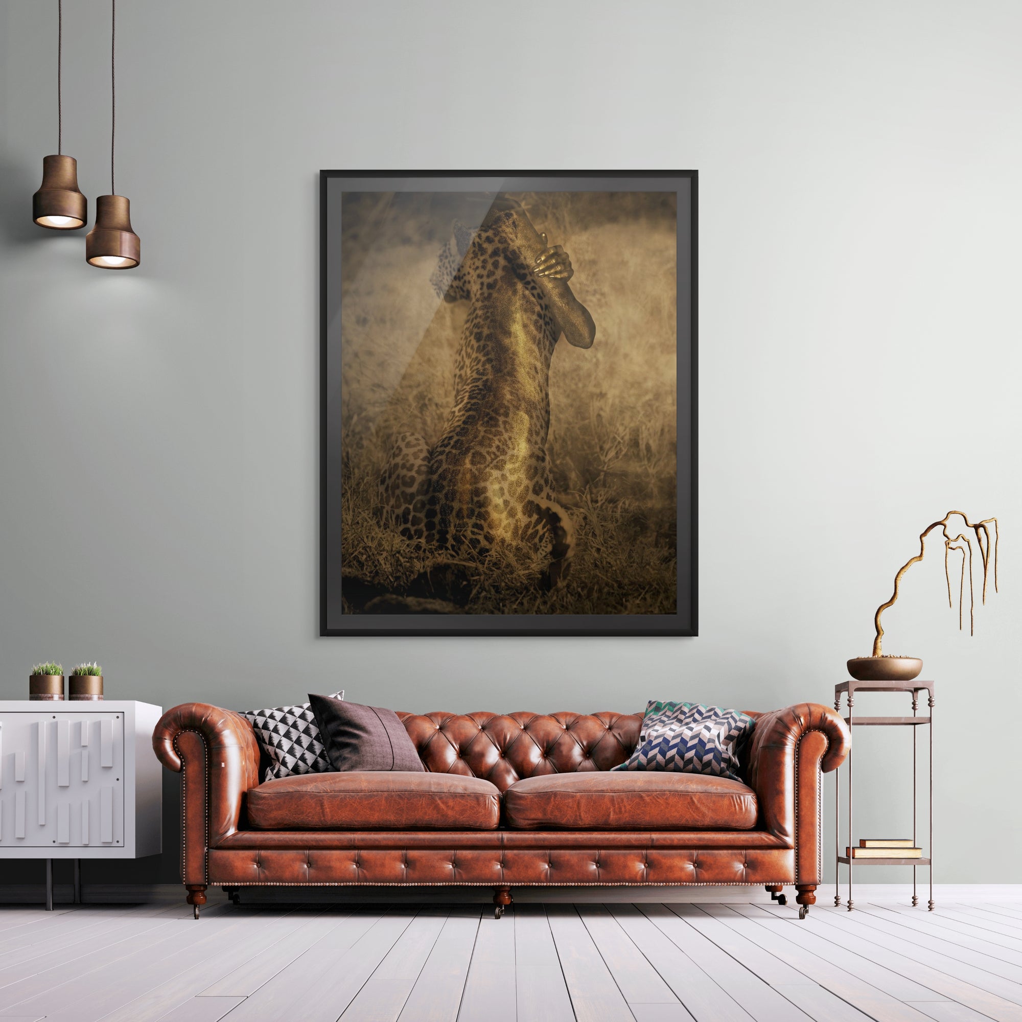 Golden leopard fusion artwork framed on a wall above a leather sofa, fine art photography print for luxury interiors and modern decor.