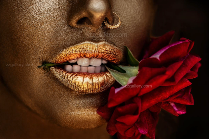 Close-up fine art photograph of golden-painted lips gently biting a red rose, symbolizing sensuality and passion, perfect as luxury wall art for modern interiors, spas, or collectors.