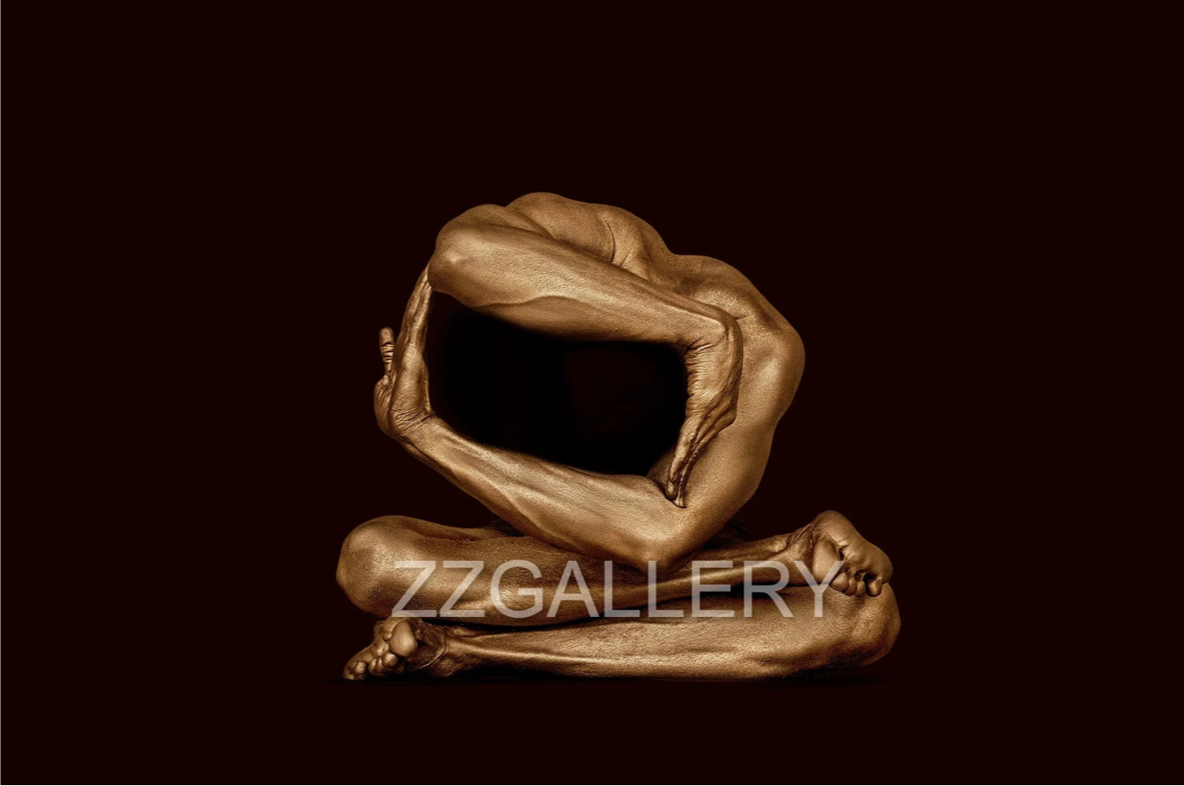 Golden-painted male figure in advanced geometric yoga pose, forming a circular shape with arms and legs, photographed by Zack Zublena. Luxury fine art photography for meditation, wellness, and modern interiors.